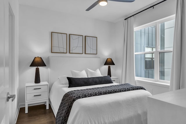 bedroom with dark hardwood / wood-style flooring, multiple windows, and ceiling fan