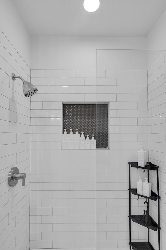 bathroom with a tile shower