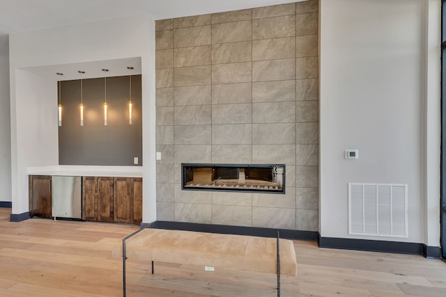 interior space featuring light hardwood / wood-style floors and a large fireplace