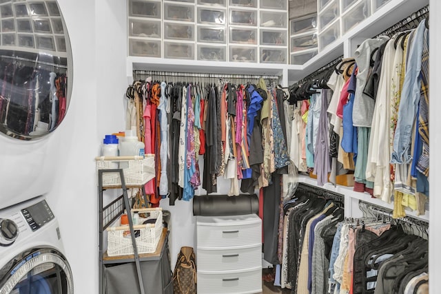 spacious closet featuring stacked washer / dryer