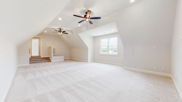 additional living space featuring lofted ceiling and light colored carpet