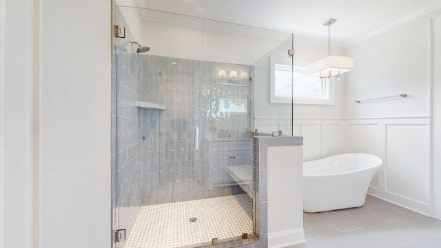 bathroom featuring tile patterned flooring, crown molding, and shower with separate bathtub