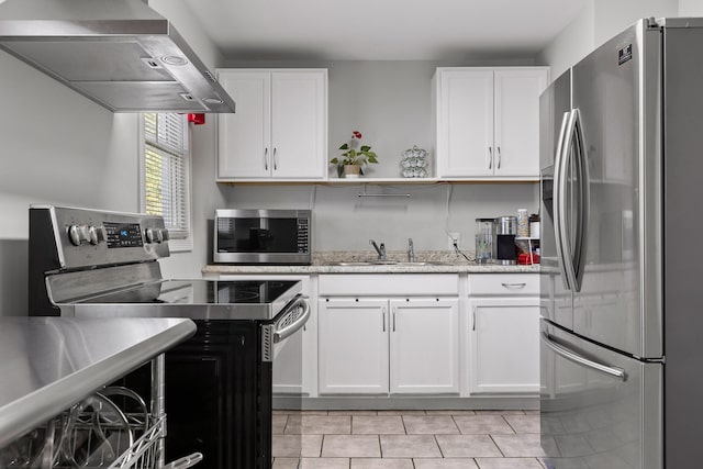 kitchen featuring white cabinetry, wall chimney exhaust hood, appliances with stainless steel finishes, and sink