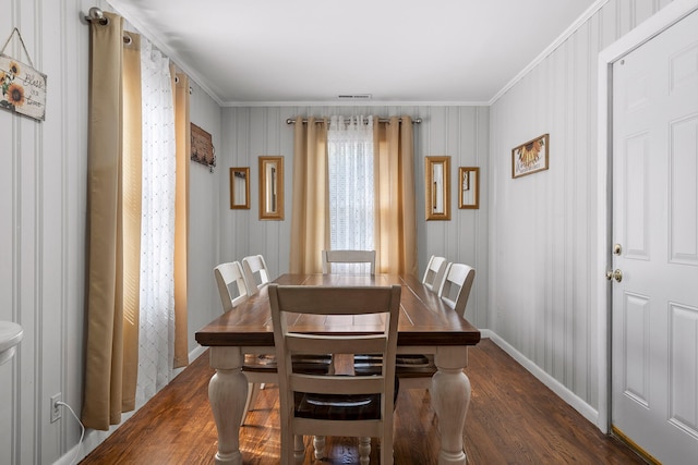 dining area featuring ornamental molding and dark hardwood / wood-style floors