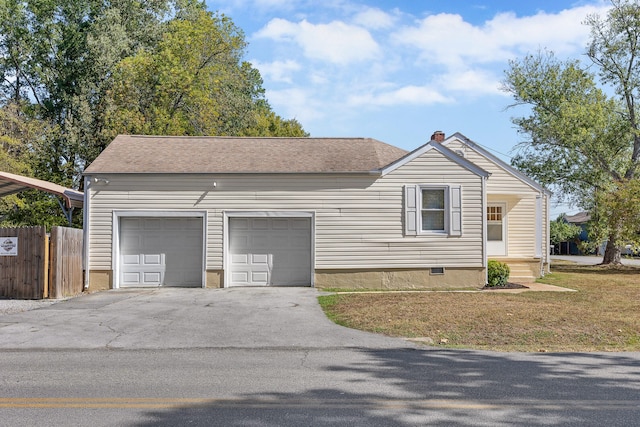 ranch-style home with a front yard and a garage