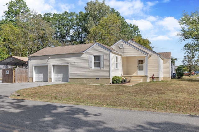 view of front of home with a garage, a front lawn, and a carport