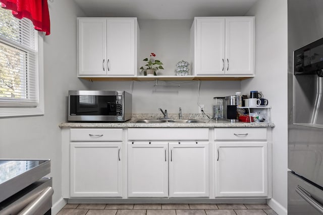 1529 Springvale Rd, Chattanooga, TN 37412 - kitchen featuring stainless steel appliances, open shelves, white cabinets, and light tile patterned floors