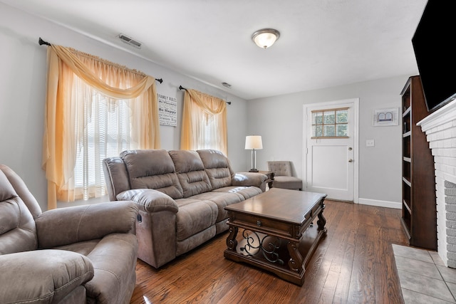 living room with a fireplace and dark hardwood / wood-style floors