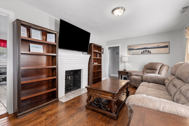 living room featuring a fireplace and hardwood / wood-style flooring