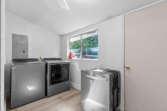 clothes washing area featuring light hardwood / wood-style floors, washer and dryer, and electric panel