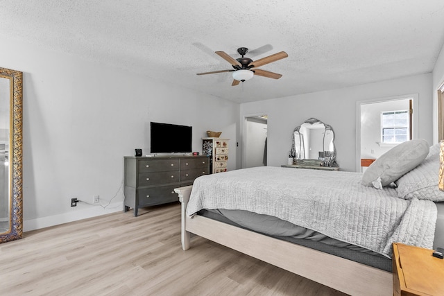 bedroom with light hardwood / wood-style flooring, a textured ceiling, and ceiling fan