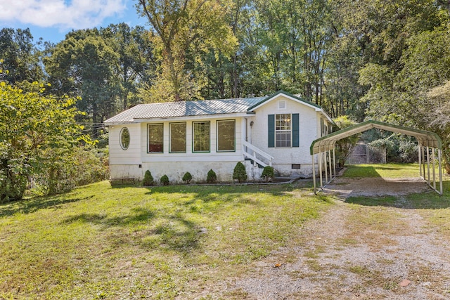 view of front facade with a carport and a front yard