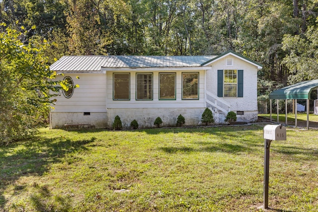 view of front of property with a front yard and a carport