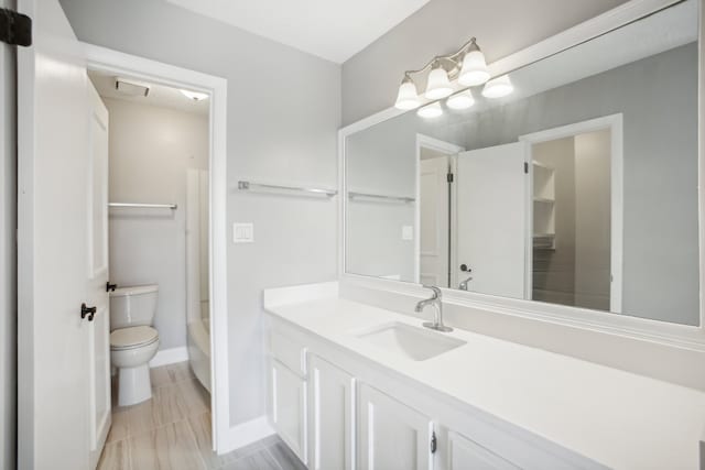 full bathroom featuring toilet, vanity, and  shower combination