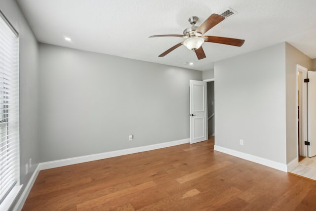 empty room with light hardwood / wood-style floors and ceiling fan