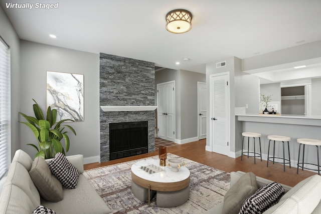 living room with hardwood / wood-style flooring and a fireplace