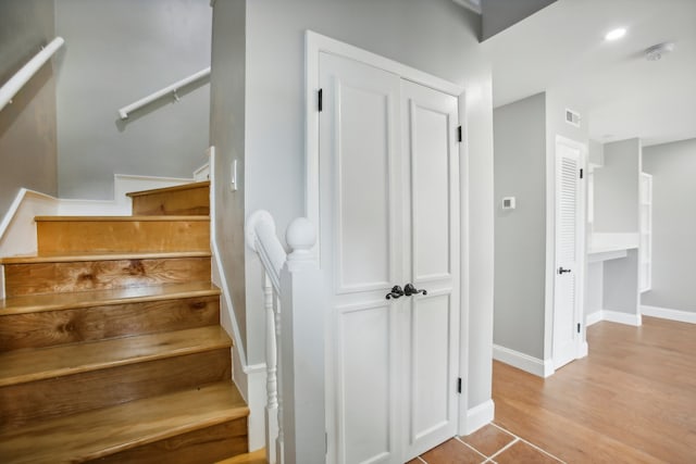 staircase featuring hardwood / wood-style flooring