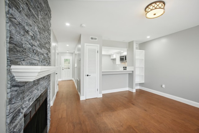 living room with hardwood / wood-style flooring and a fireplace