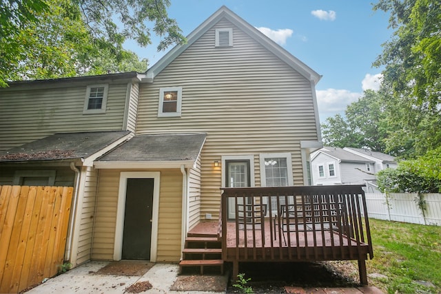 rear view of property featuring a deck