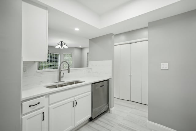 kitchen with white cabinetry, dishwasher, sink, and backsplash