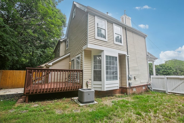 back of house featuring a wooden deck, central AC, and a yard