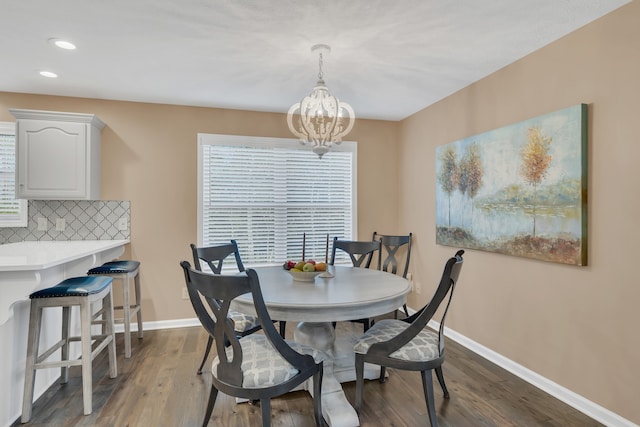 dining room with a chandelier and dark hardwood / wood-style flooring