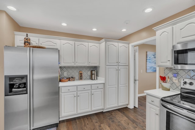 kitchen featuring white cabinetry, appliances with stainless steel finishes, dark hardwood / wood-style flooring, and decorative backsplash