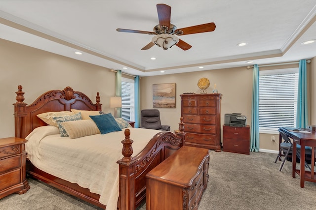 carpeted bedroom with multiple windows, ornamental molding, a raised ceiling, and ceiling fan