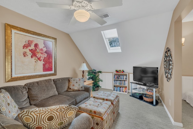 living room with lofted ceiling with skylight, light colored carpet, and ceiling fan