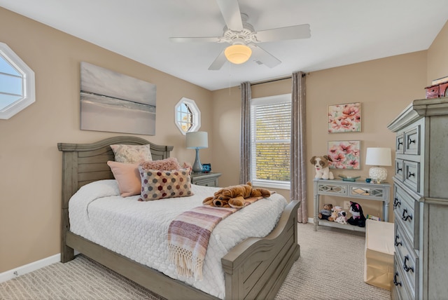 bedroom with light carpet and ceiling fan