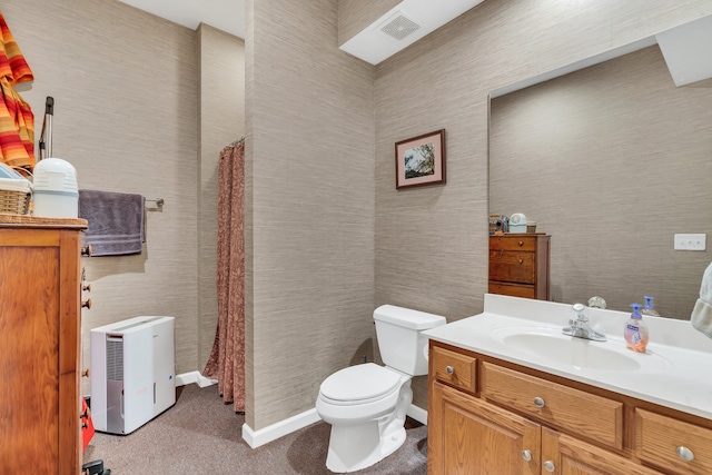 bathroom featuring vanity, curtained shower, and toilet