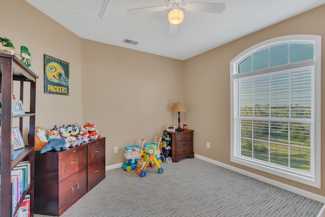 game room with ceiling fan and light colored carpet