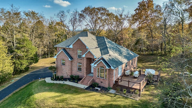 exterior space featuring a front lawn and a deck