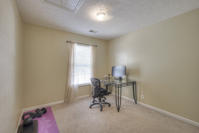 office featuring light carpet and a textured ceiling