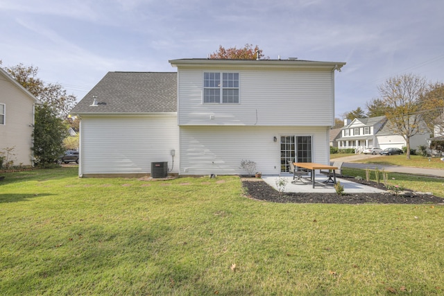 rear view of house with a lawn, central air condition unit, and a patio