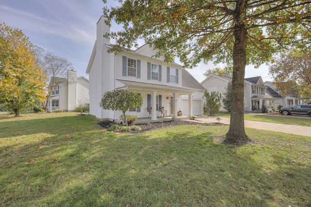 view of front of property with a porch, a front yard, and a garage