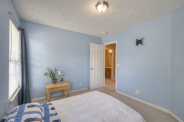 carpeted bedroom featuring a textured ceiling and multiple windows