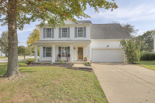 view of front of house with a front lawn, covered porch, and a garage