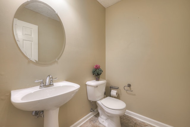 bathroom featuring toilet and sink