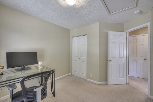 office with light carpet and a textured ceiling