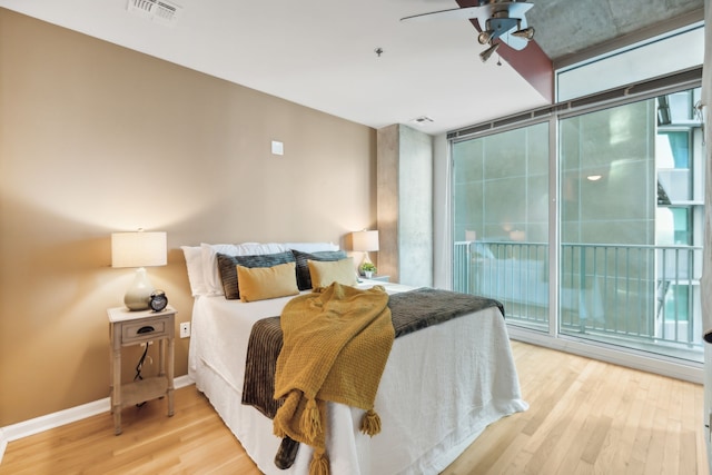 bedroom featuring ceiling fan, wood-type flooring, and access to exterior