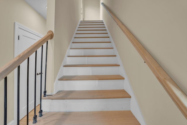 stairs featuring hardwood / wood-style flooring