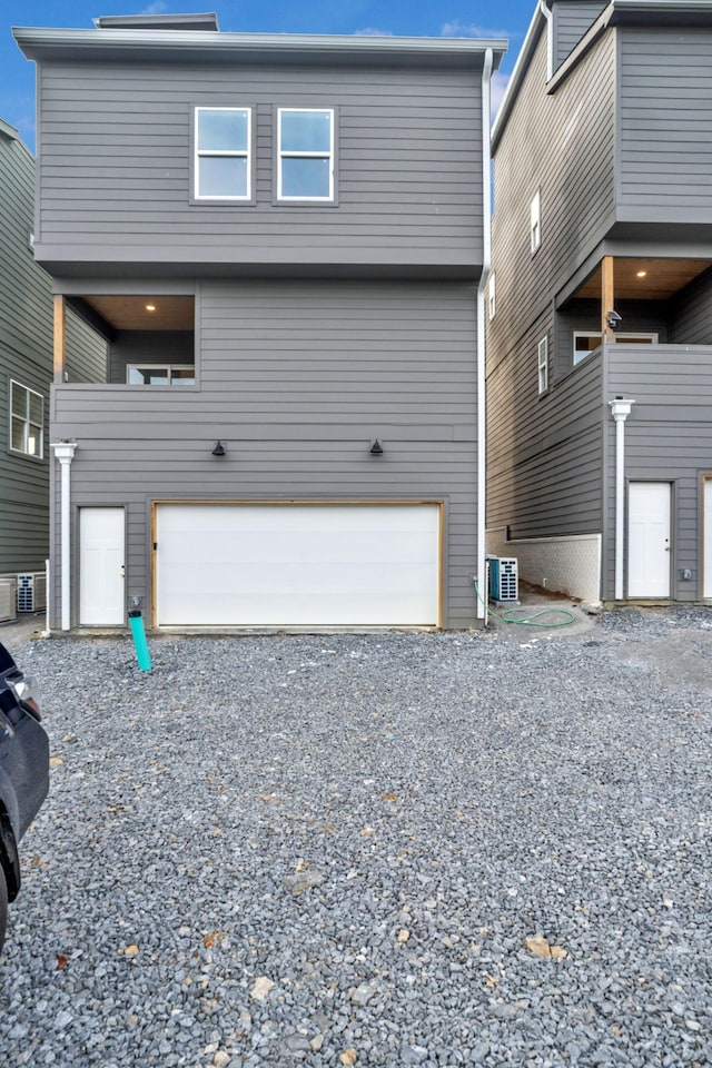 exterior space featuring central air condition unit and a garage