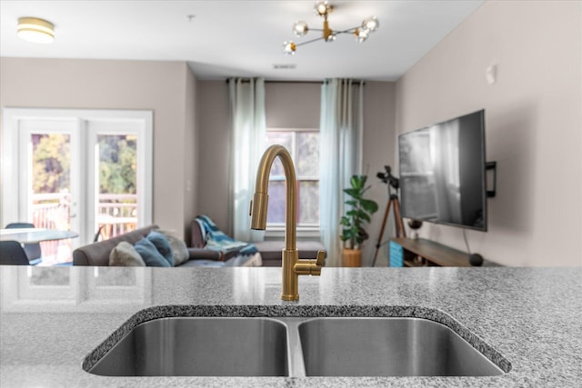 kitchen featuring light stone countertops and sink