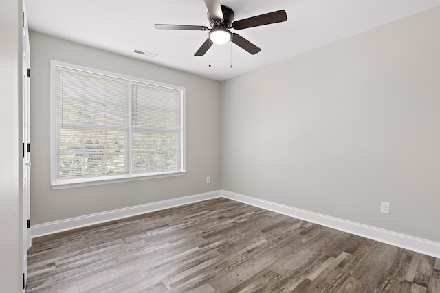 empty room with hardwood / wood-style flooring and ceiling fan