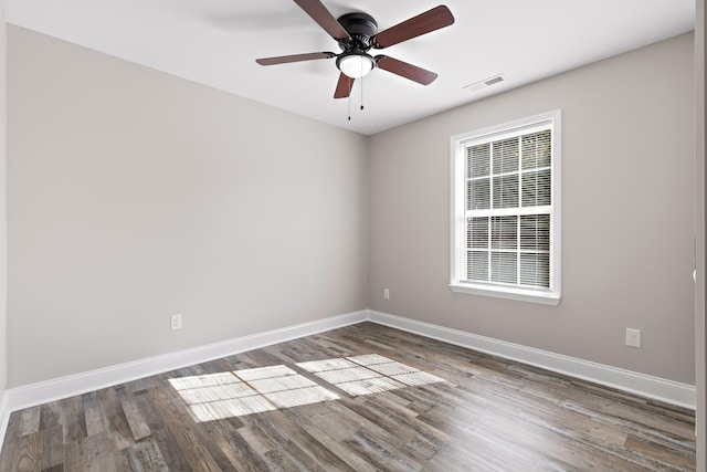 unfurnished room featuring ceiling fan and dark hardwood / wood-style floors