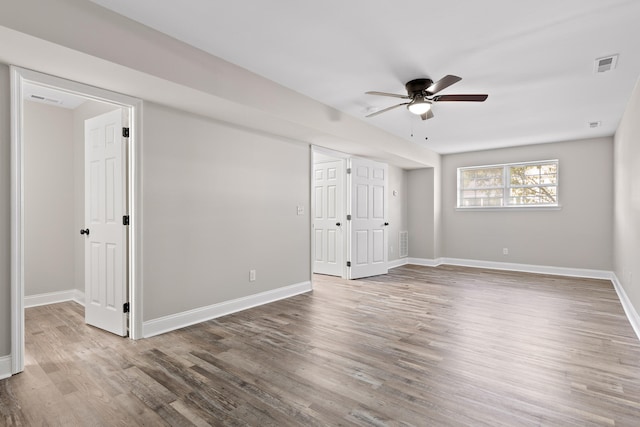 unfurnished bedroom featuring hardwood / wood-style floors and ceiling fan