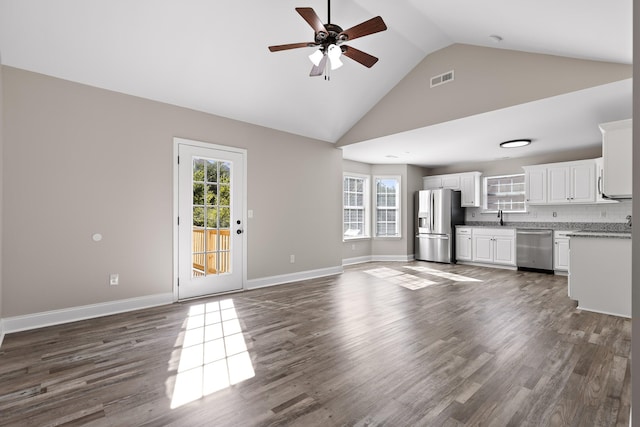 unfurnished living room featuring high vaulted ceiling, dark wood-type flooring, sink, and ceiling fan