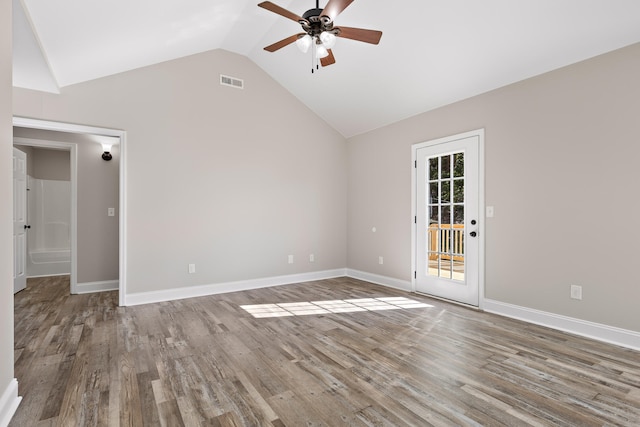 spare room with lofted ceiling, hardwood / wood-style flooring, and ceiling fan