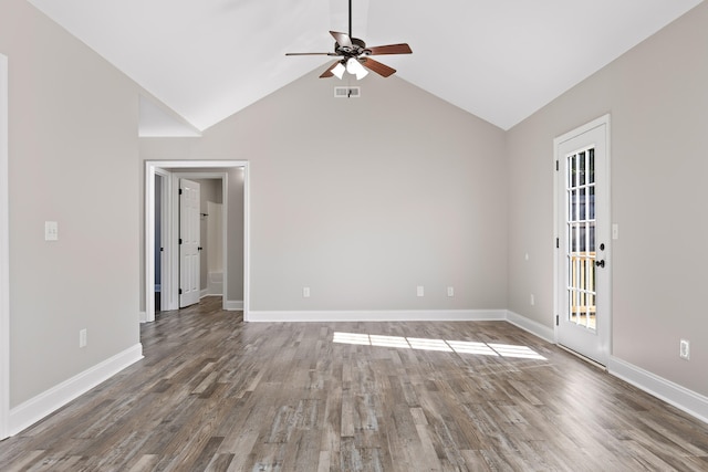 empty room with ceiling fan, hardwood / wood-style flooring, and vaulted ceiling